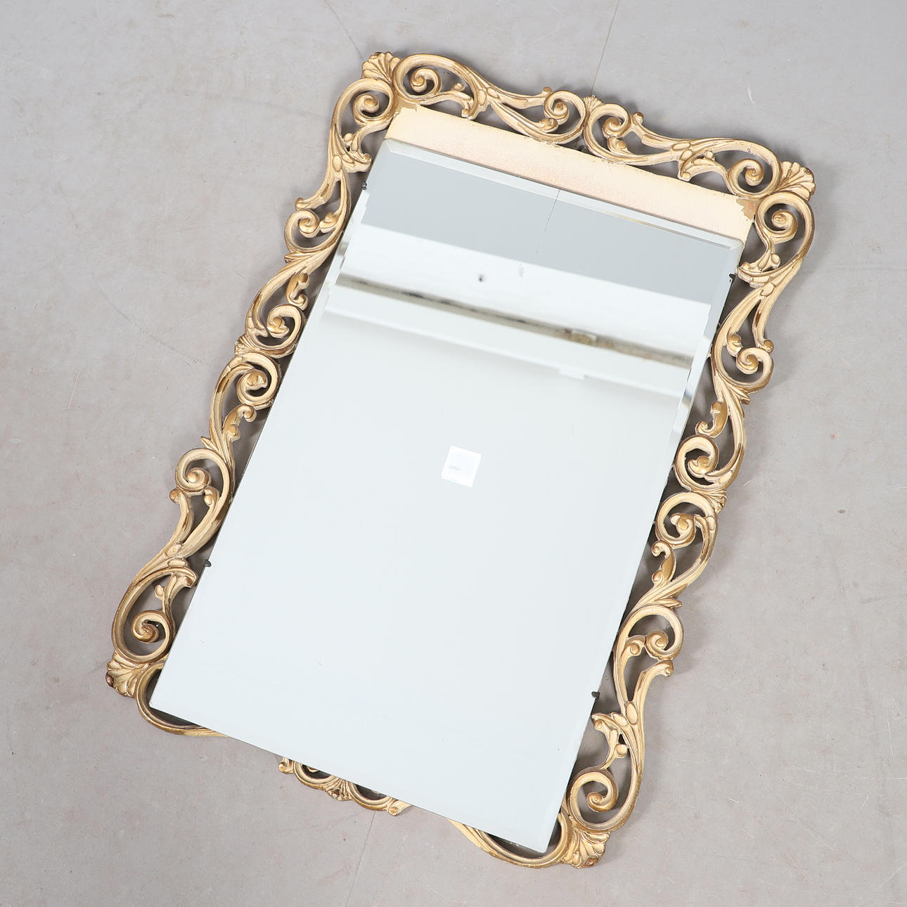 A MID-20TH CENTURY SCROLL FRAME WALL MIRROR.