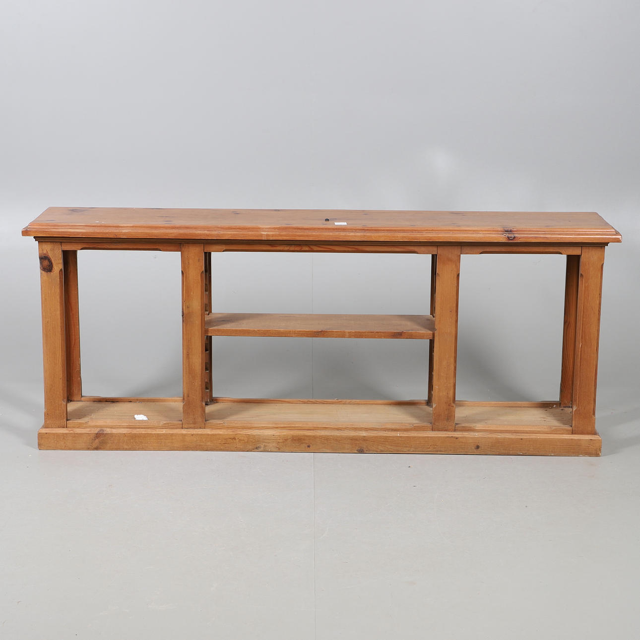 A NARROW PINE LOW OPEN BOOKSHELF/STAND.