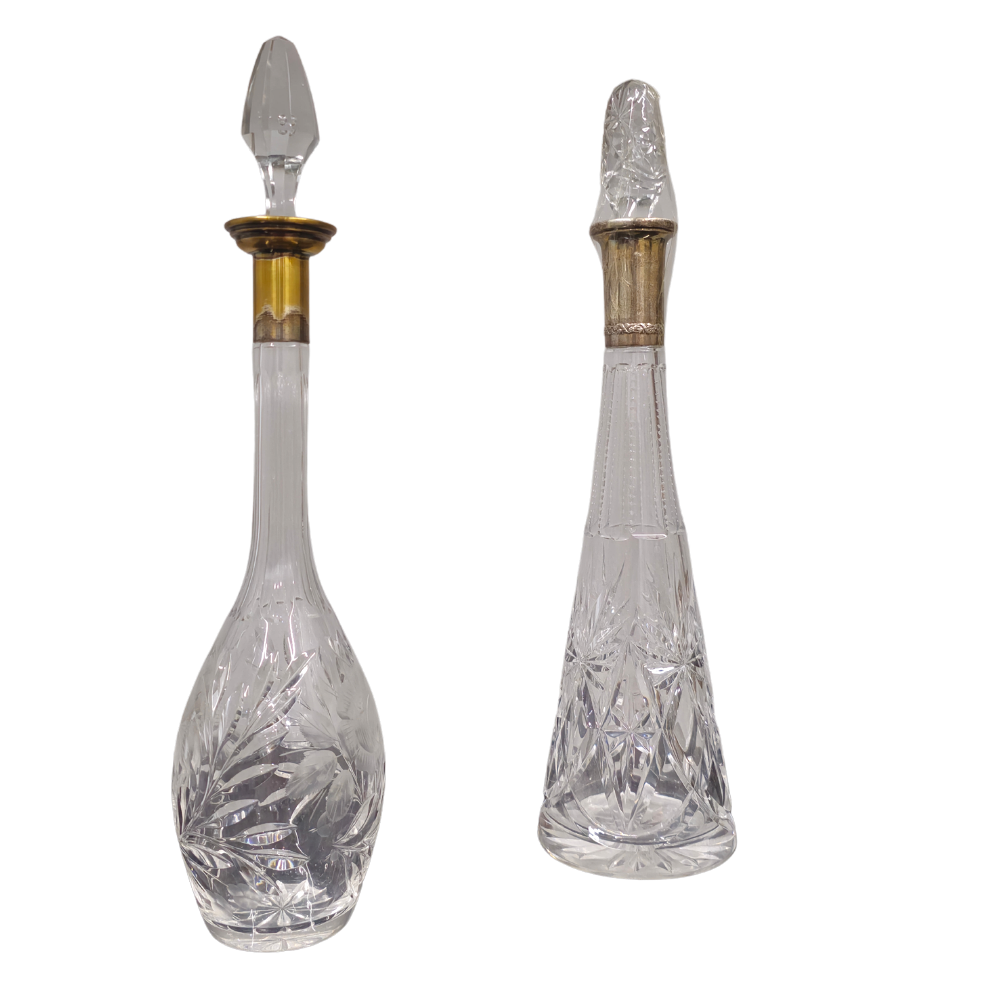 2 cut glass decanters, one with a silver neck.