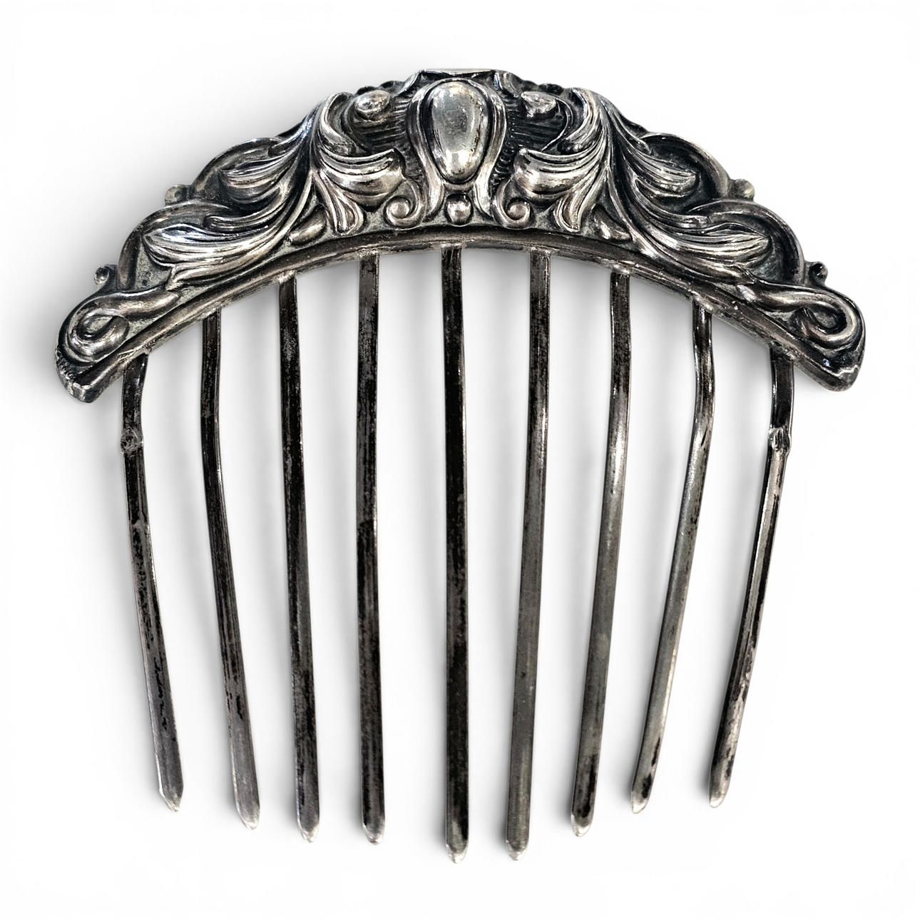 Silver hair comb with scrollwork.