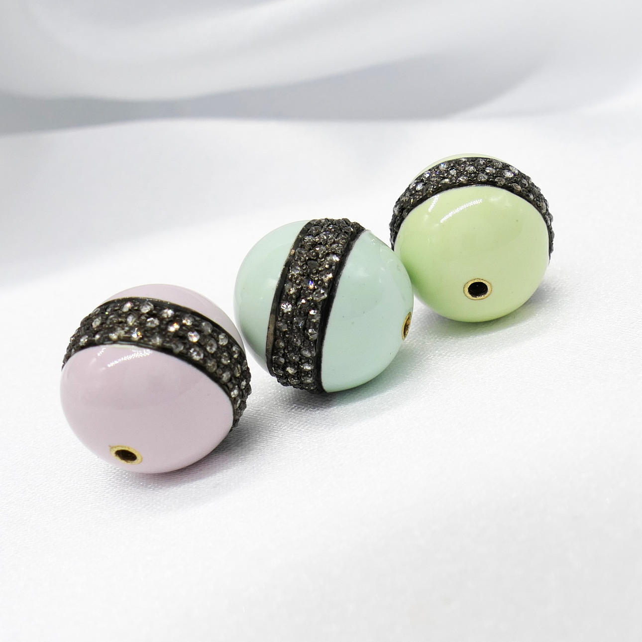 THREE ENAMELLED DIAMOND beads.