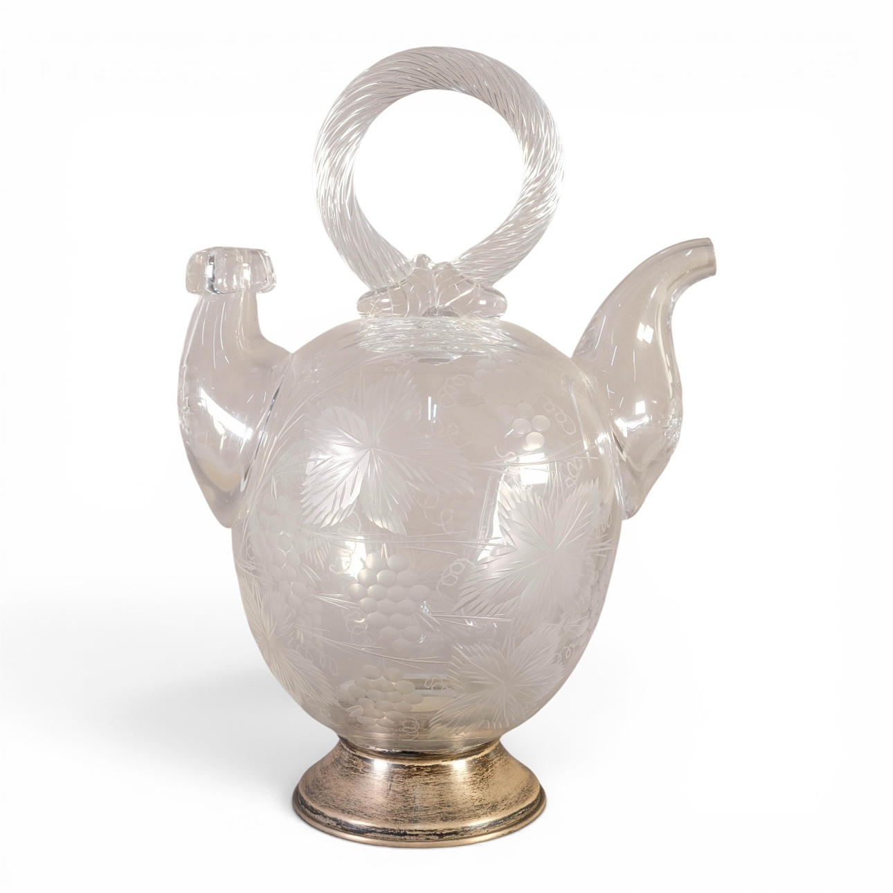 Cut glass water jug with silver base.