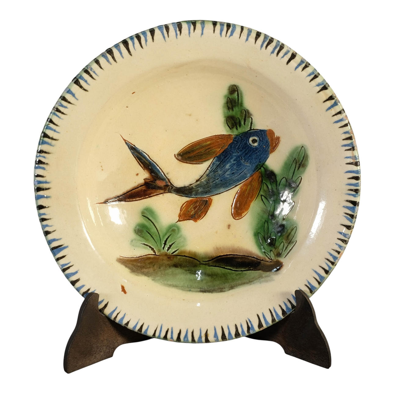 Glazed ceramic dish. Decorated with fish.