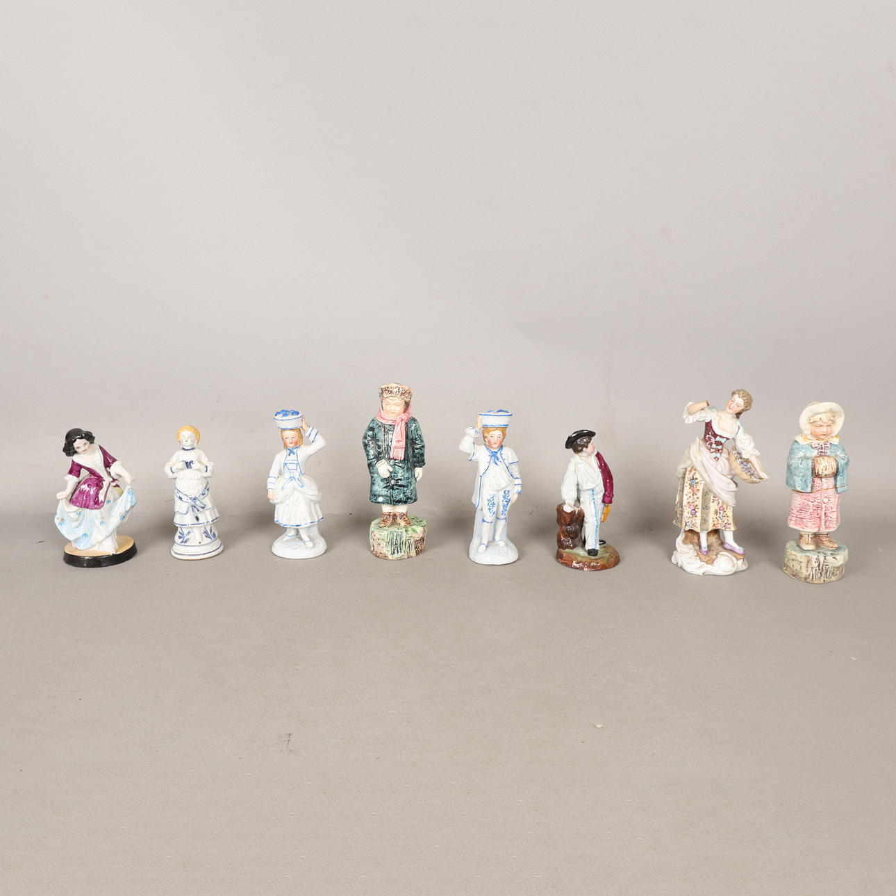 A COLLECTION OF CERAMIC FIGURES (8).