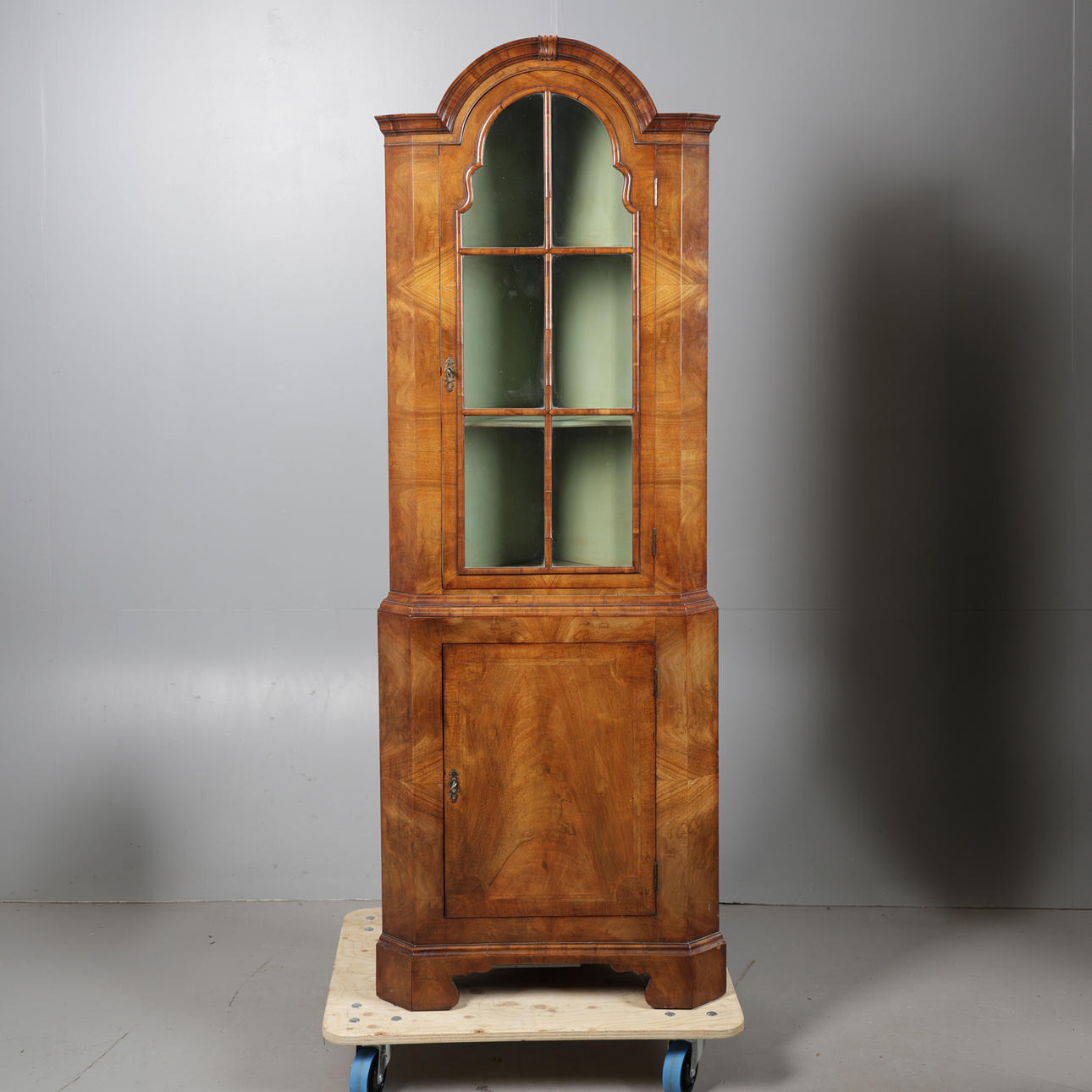A GEORGE III STYLE WALNUT CORNER CUPBOARD.