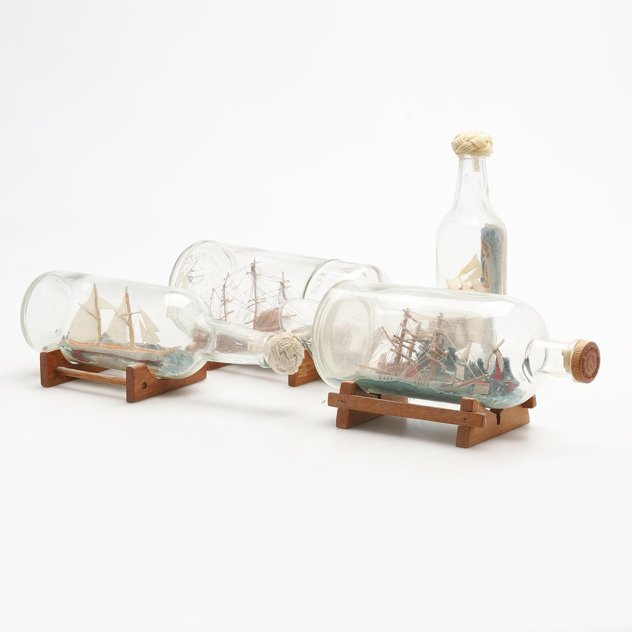 SHIP IN A BOTTLE. 4 pcs, 20th century.