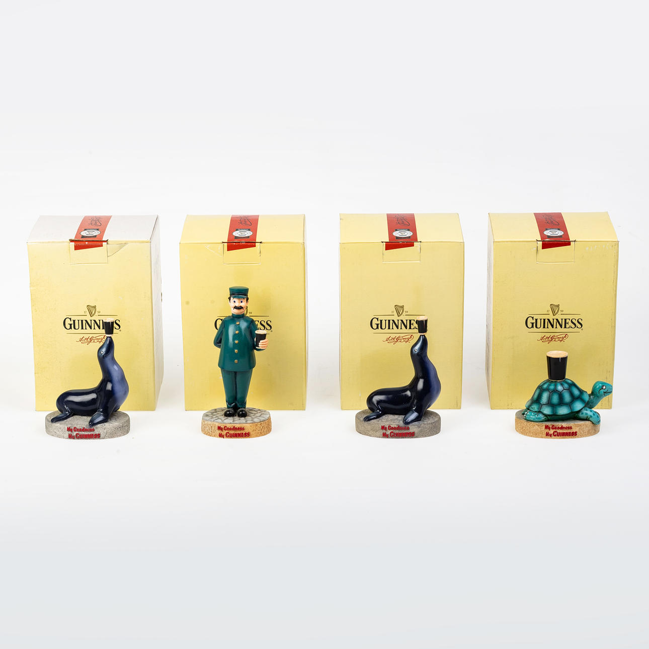 FOUR GUINNESS CERAMIC FIGURINES.