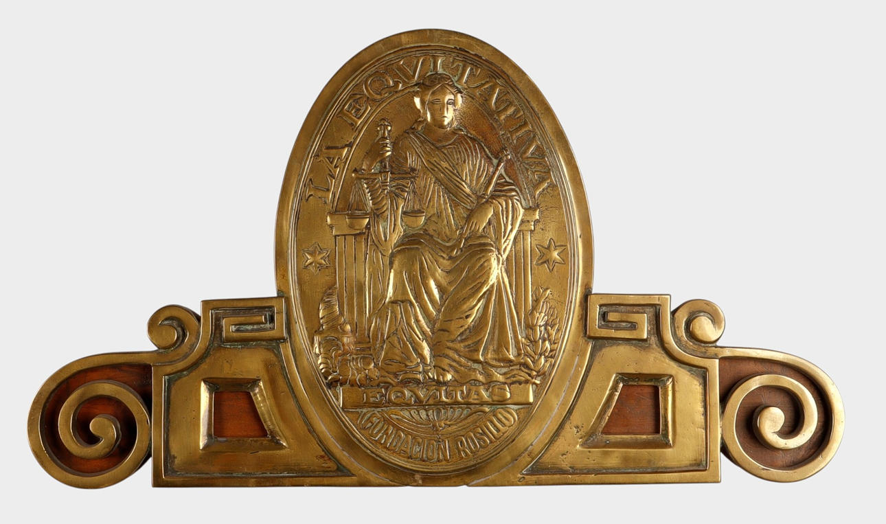 La Equitativa brass bas-relief finial.