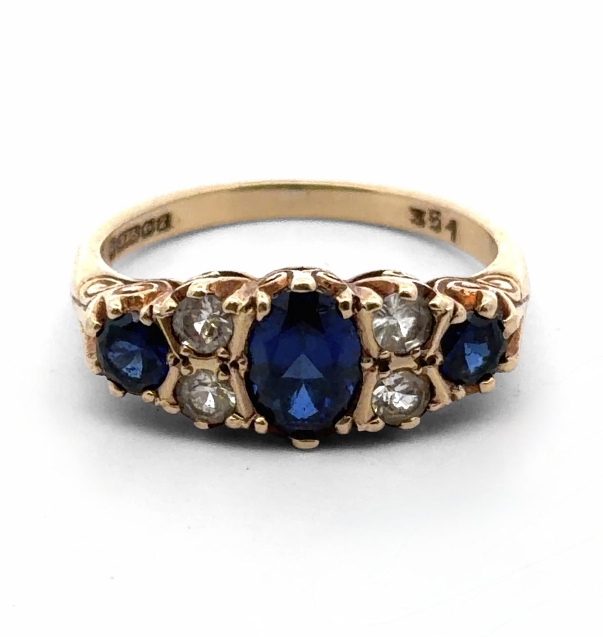 SYNTHETIC SAPPHIRE AND WHITE STONE RING.