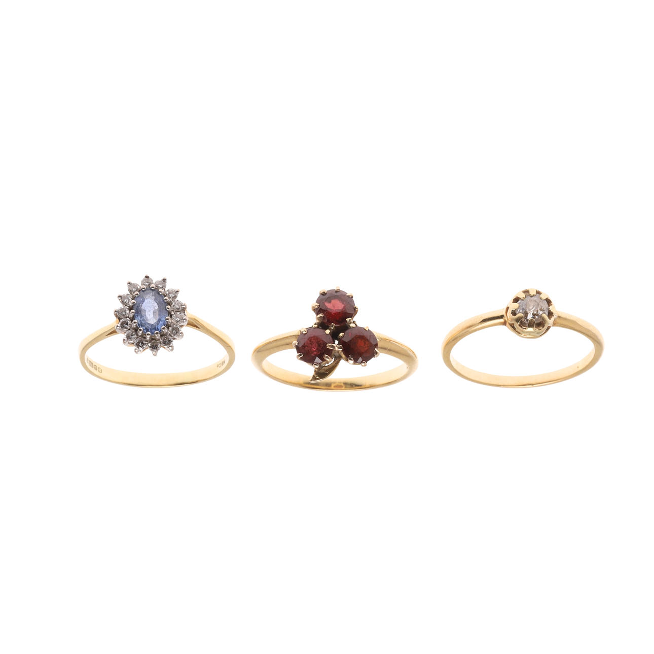 THREE GOLD AND GEM SET RINGS.