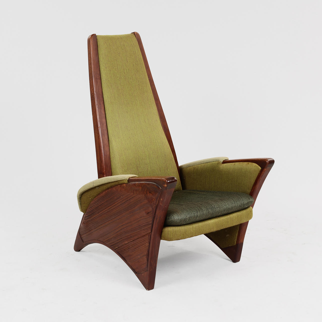 High-backed 'brutalist' armchair in stained pine.