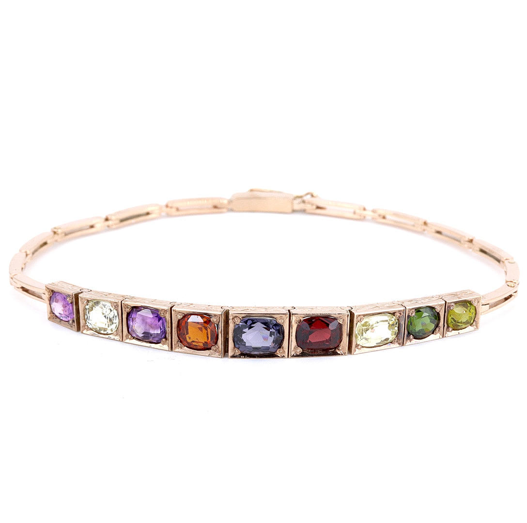 ARMBAND I 9KT GULD MED ÄDELSTENAR.