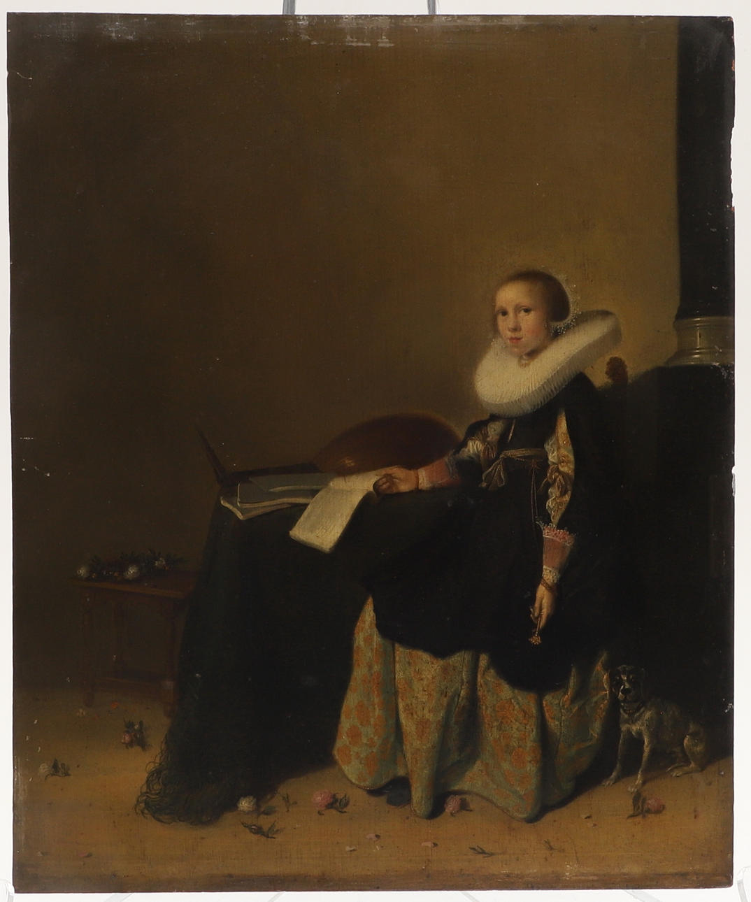 ATTRIBUTED TO HENDRIK GERRITSZ POT (CIRCA 1580-1657). AN INTERIOR SCENE WITH A LADY SAT AT A TABLE.