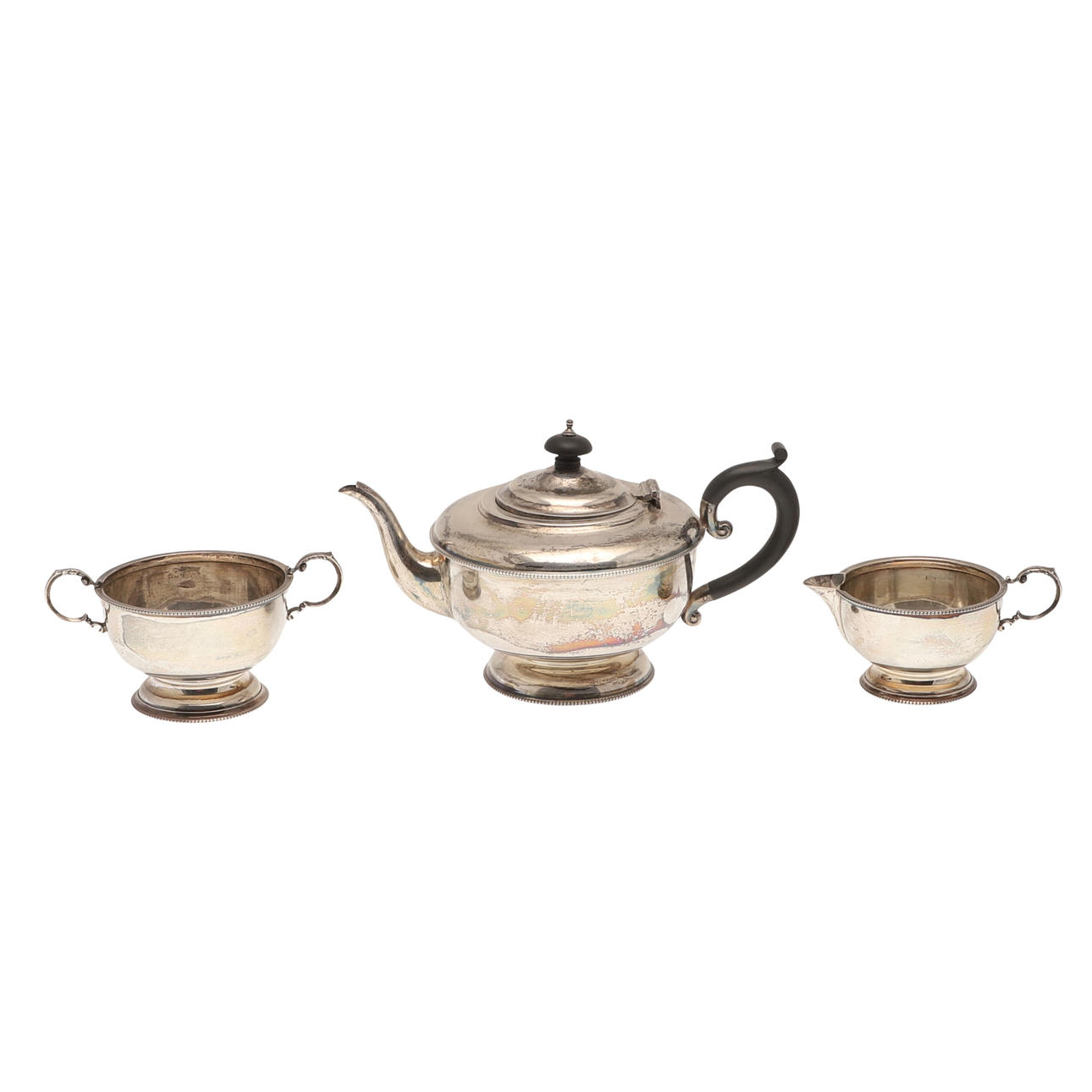 A GEORGE V SILVER THREE PIECE TEASET.