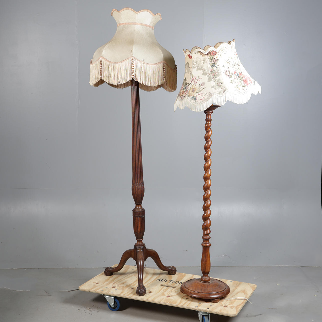 A WALNUT AND A MAHOGANY STANDARD LAMP (2).