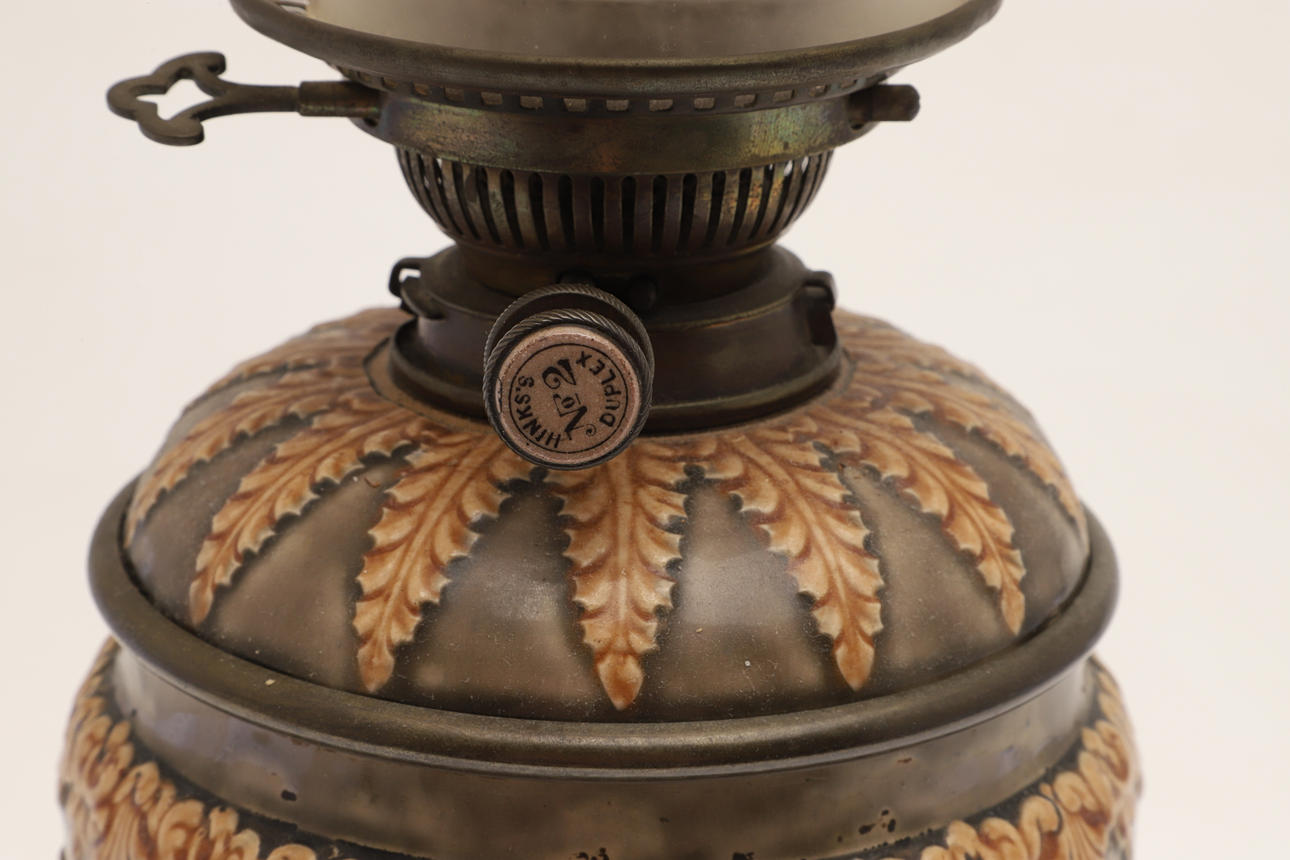 A VICTORIAN STONEWARE OIL LAMP AND REPRODUCTION GLASS SHADE. Lighting ...