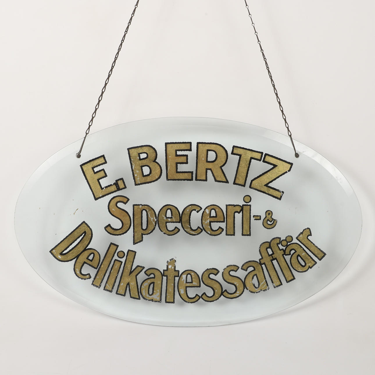 AFFÄRSSKYLT, målat glas, E. Bertz Speceri-& Delikatessaffär.