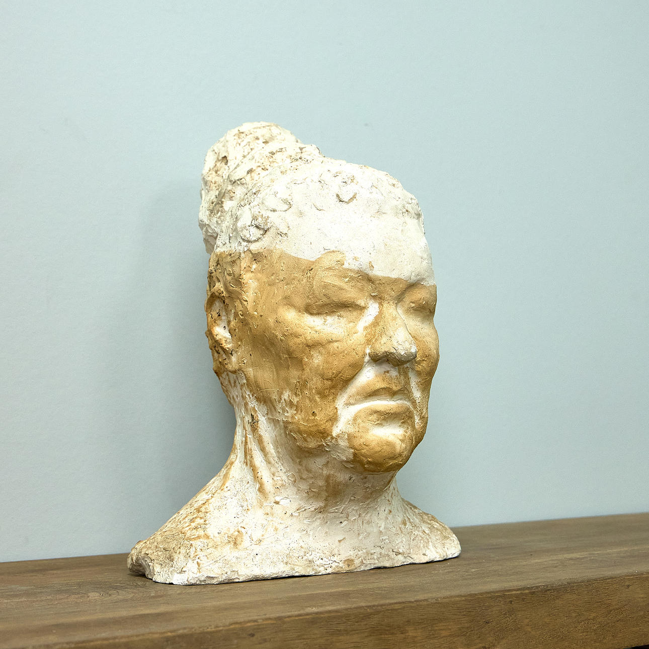 Expressionist female bust with hair bun, plaster.
