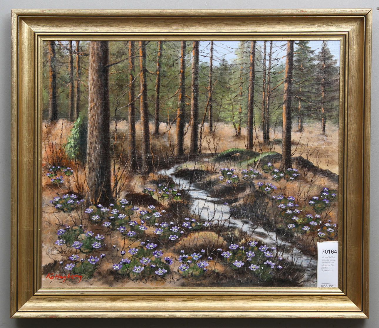 KE HAGBERG. Skogslandskap med tallar och blåsippor. Olja på duk. Signerad.