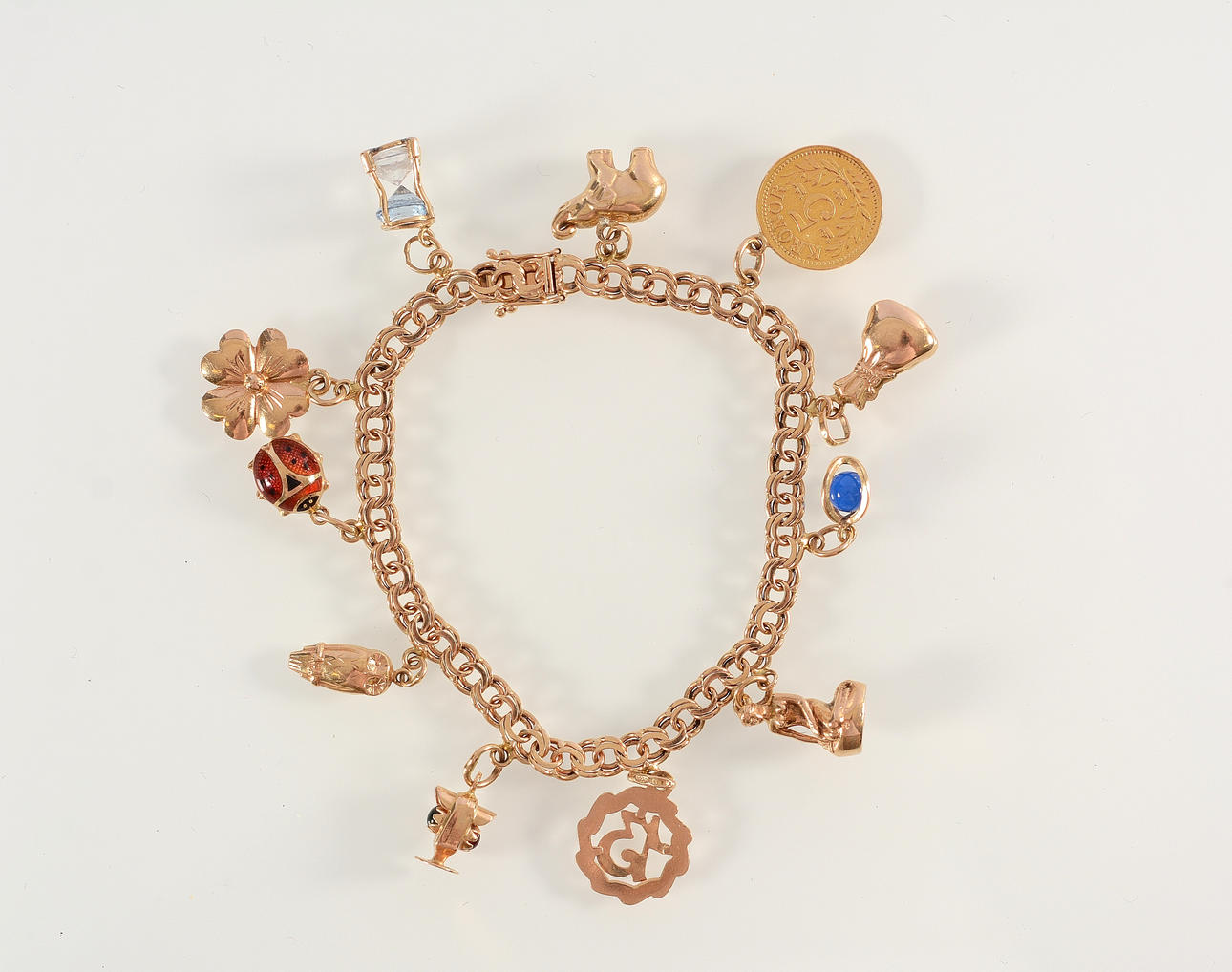 ARMLÄNK MED BERLOCKER, 18K.