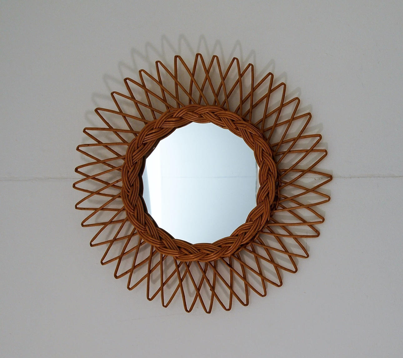 "SUN MIRROR" IN RATTAN.