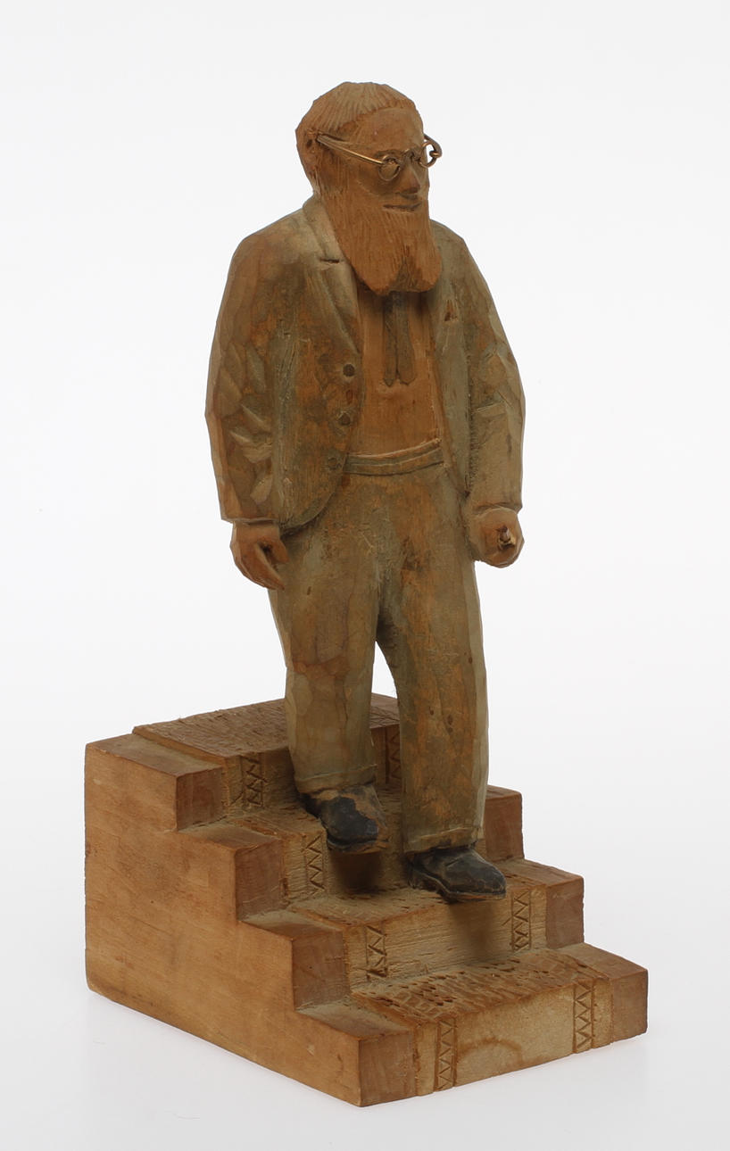 TRÄFIGUR, man på trappa, signerad OJ samt daterad 1949.