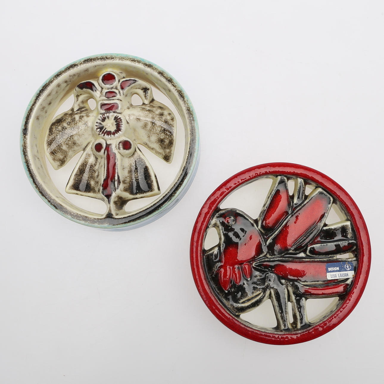 LISA LARSON, "Peacock" and "Butterfly", two rounds, glazed.