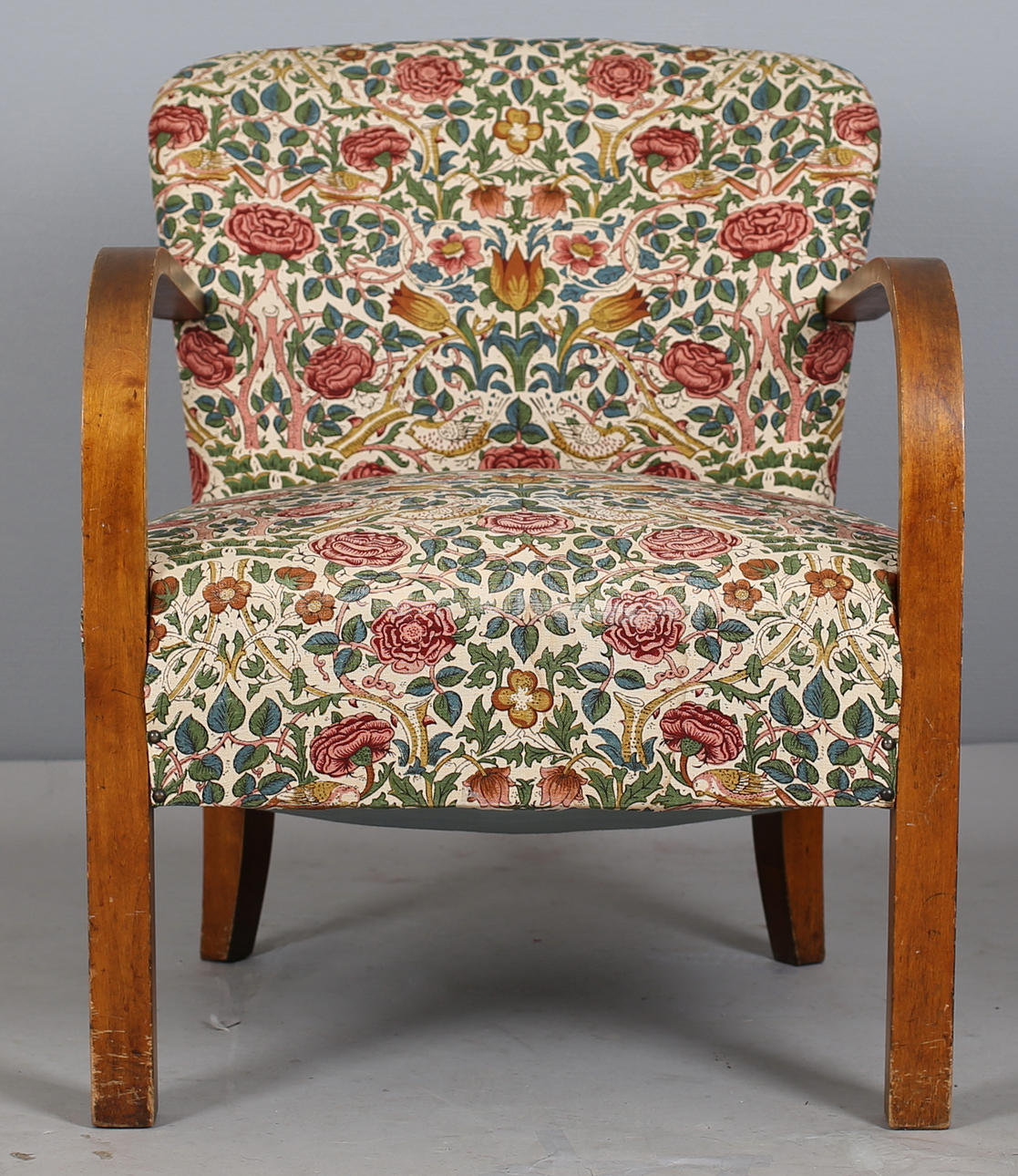 FÅTÖLJ i blommigt tyg med brunbetsade mejdar, 1940-tal.