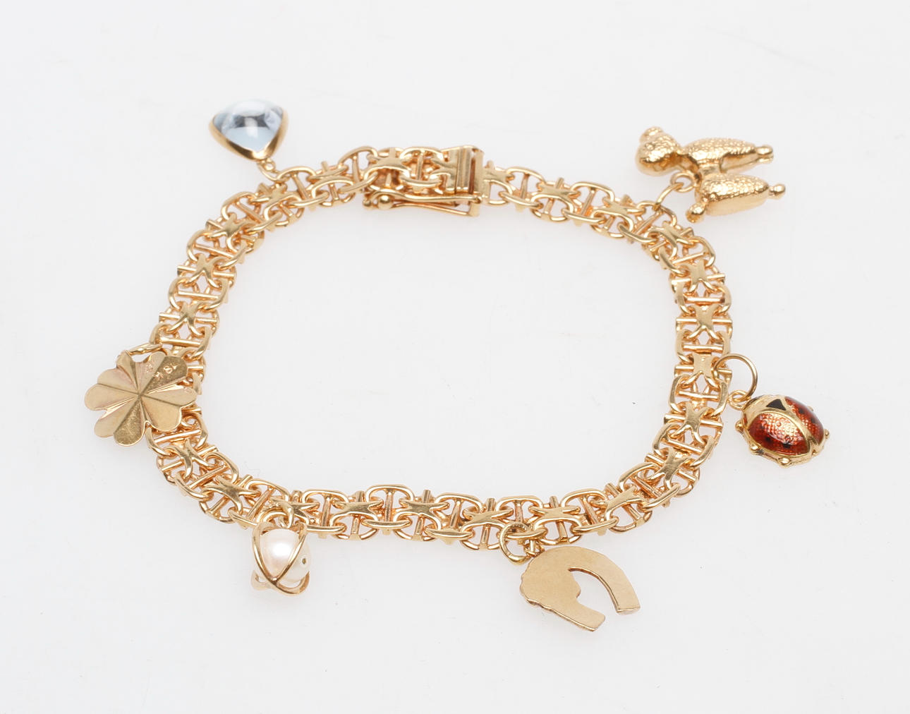 ARMBAND X-LÄNK MED BERLOCKER, 18k guld, total vikt ca 21 gr.