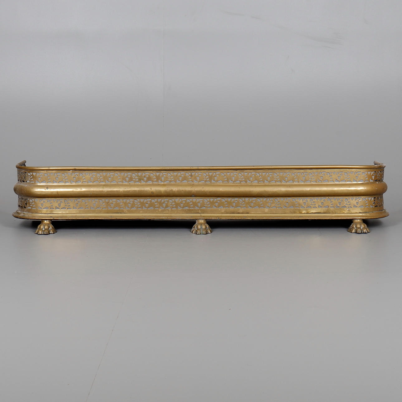 A REGENCY BRASS FENDER.