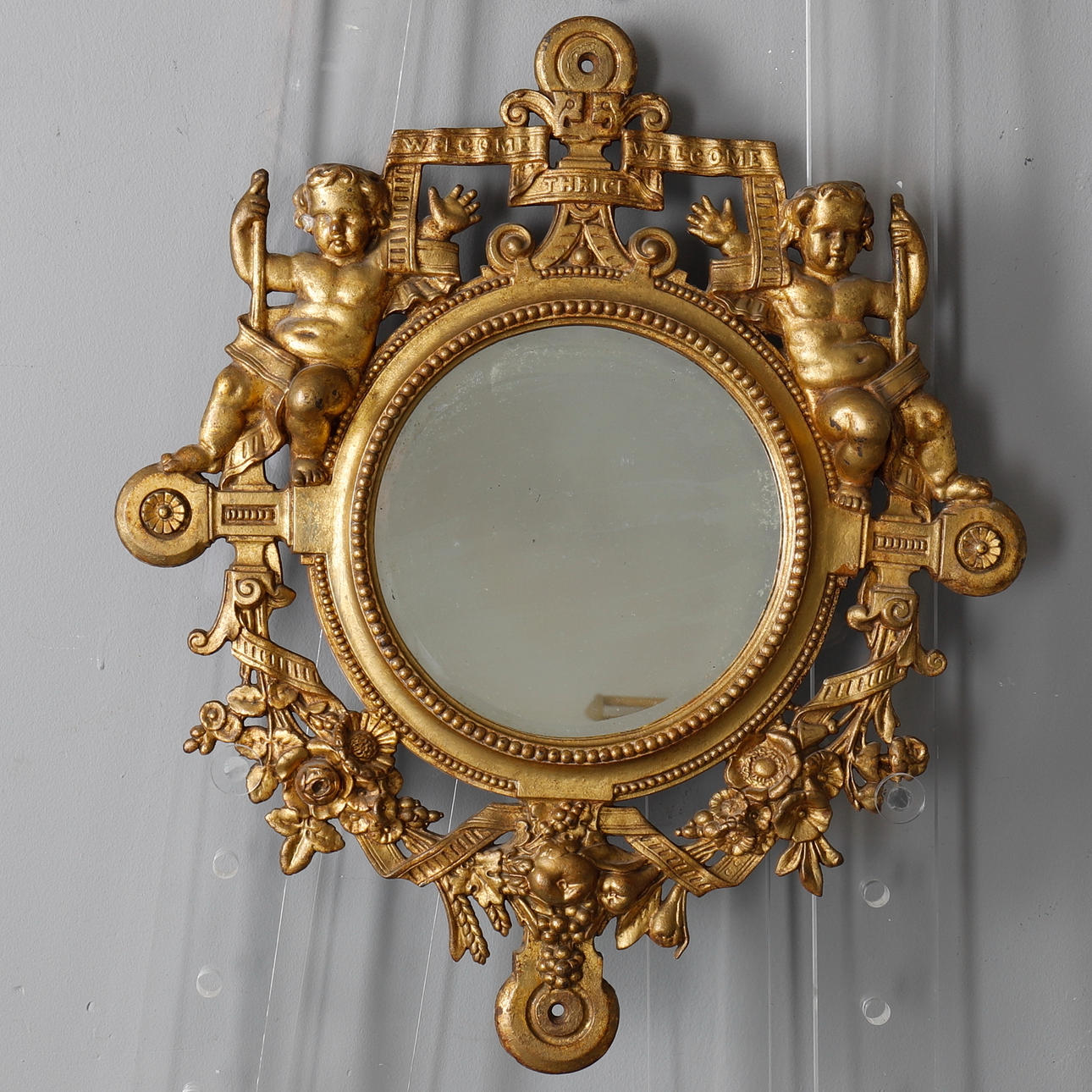 A VICTORIAN CAST IRON GOLD PAINTED MIRROR.