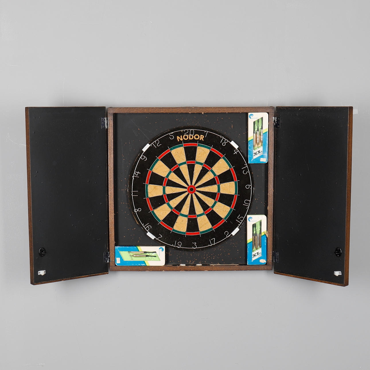 A DARTS BOARD IN AN OAK CASE.