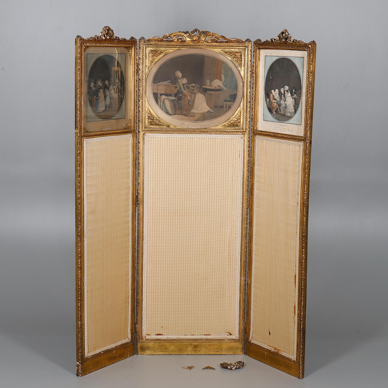 A FRENCH GILTWOOD AND COMPOSITION THREE FOLD SCREEN.