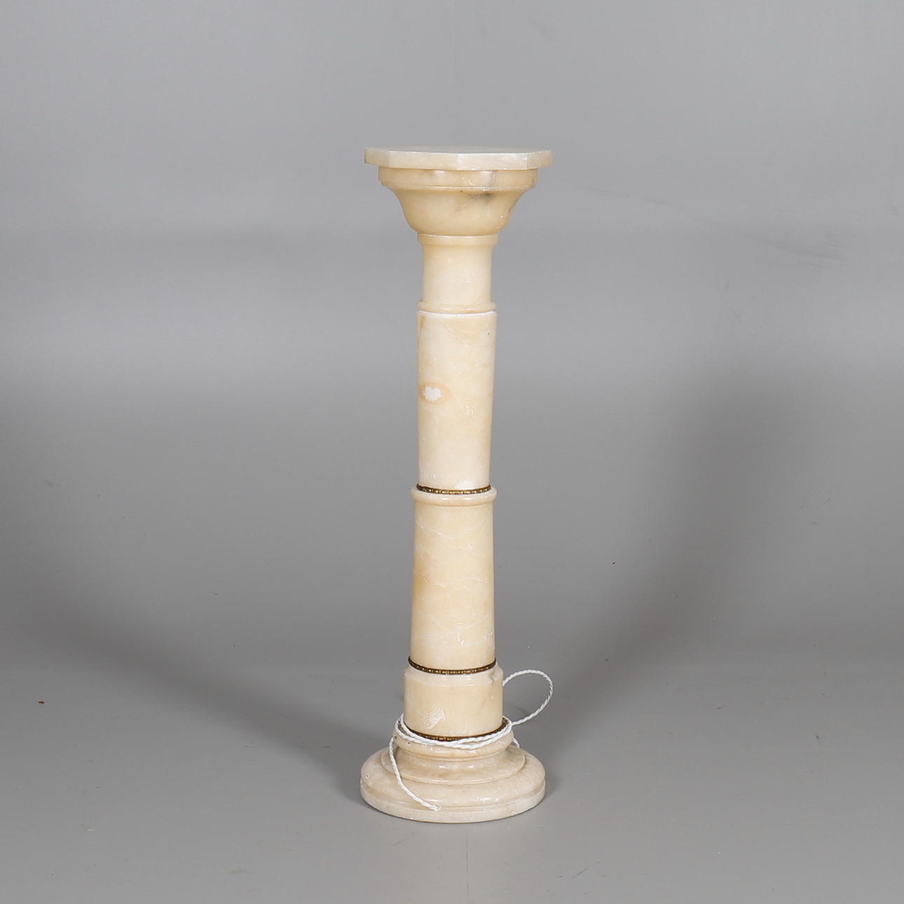 AN ALABASTER COLUMN LAMP.