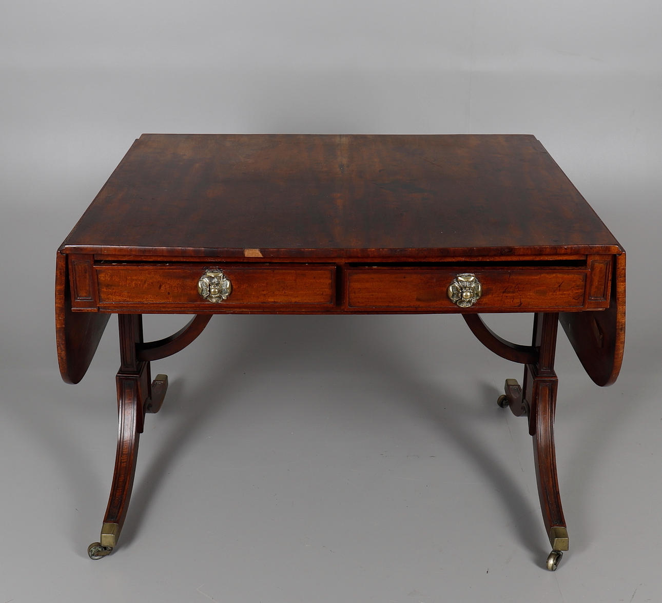A REGENCY STYLE MAHOGANY SOFA TABLE.