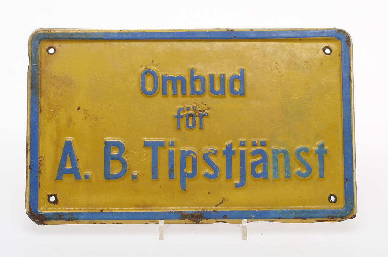 SKYLT, metall, "Ombud för A. B. Tipstjänst".