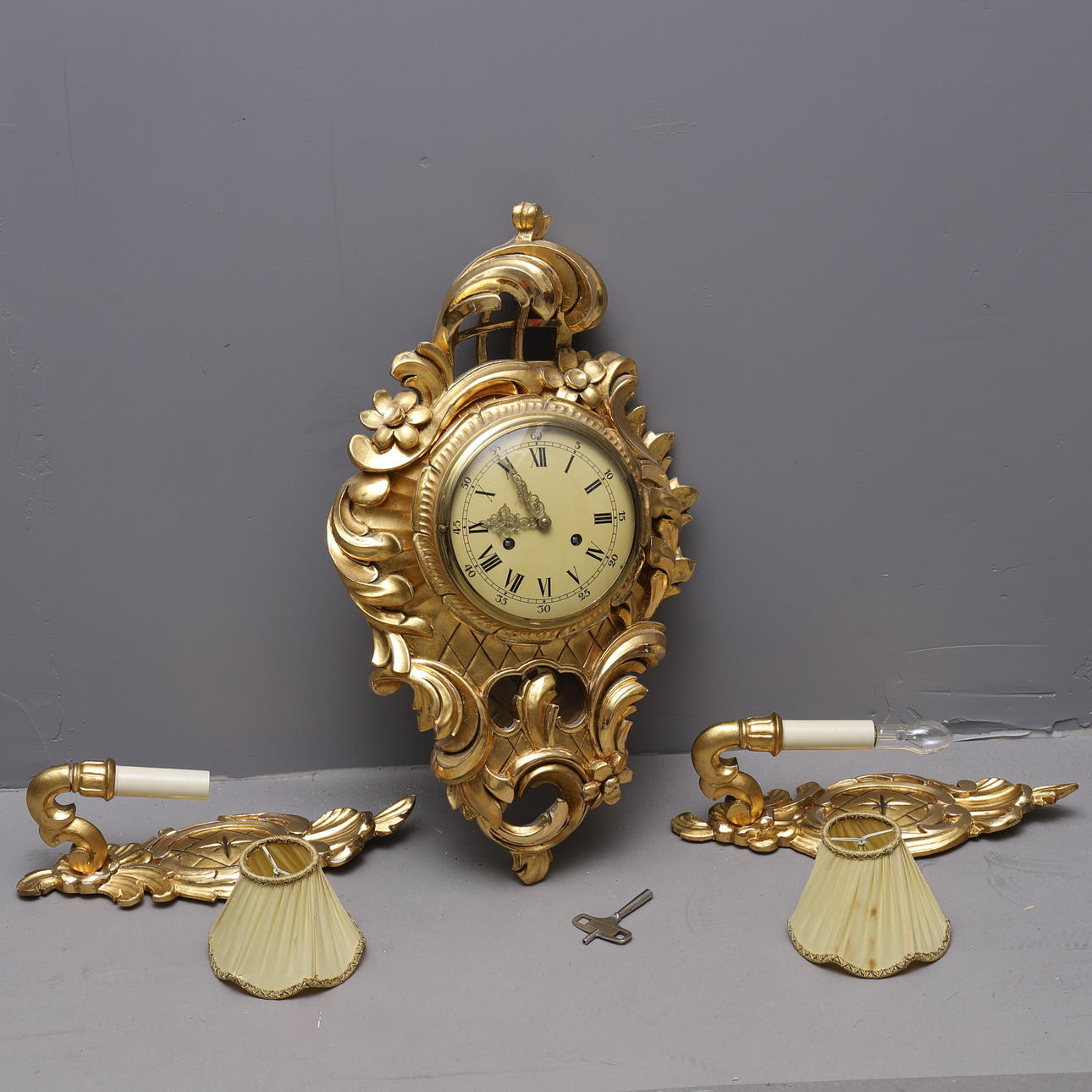 GOLD PENDULUM & LAMPS, rococo style, 20th century.
