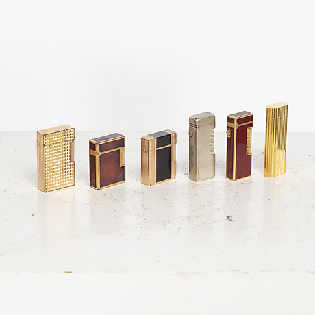 Three Dupont lighters, two Dunhill lighters and a Cartier