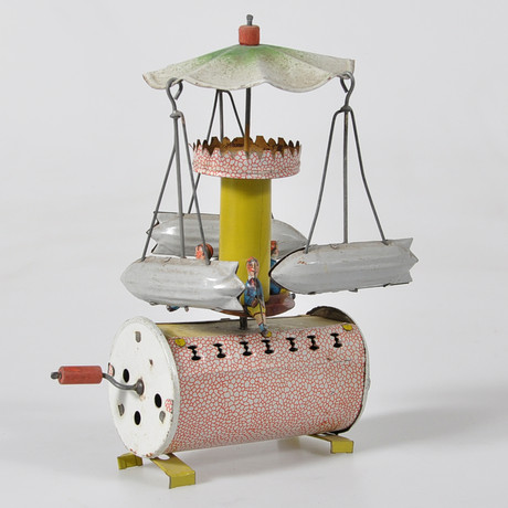 TIN TOY GERMANY AROUND 1930- CAROUSEL WITH ZEPPELIN. Toys - Auctionet