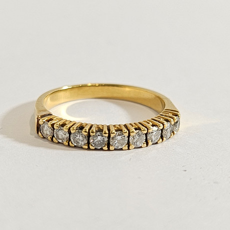 BRILLIANT-CUT DIAMOND HALF WEDDING RING. 18K YELLOW GOLD FRAME ...