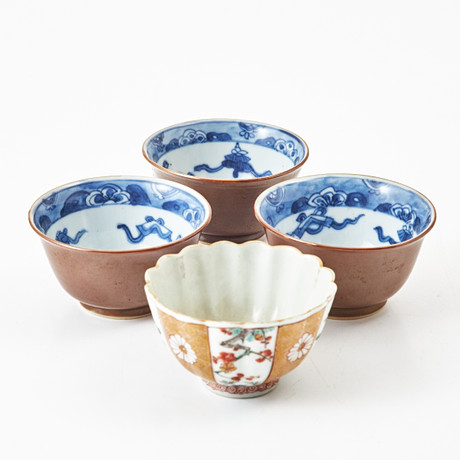 A set of four 18th century china cups, three of which are decorated in ...