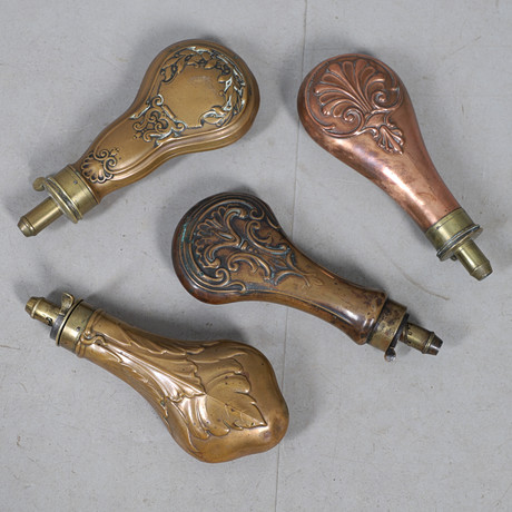 A COLLECTION OF FOUR VICTORIAN AND LATER COPPER BODIED POWDER FLASKS ...