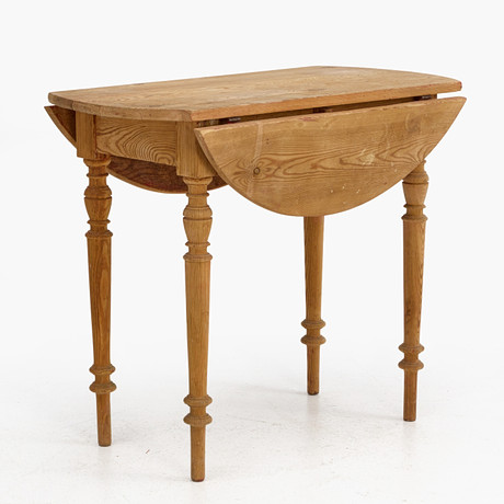 A folding table, pine, circa 1900, round with two flaps, turned legs ...