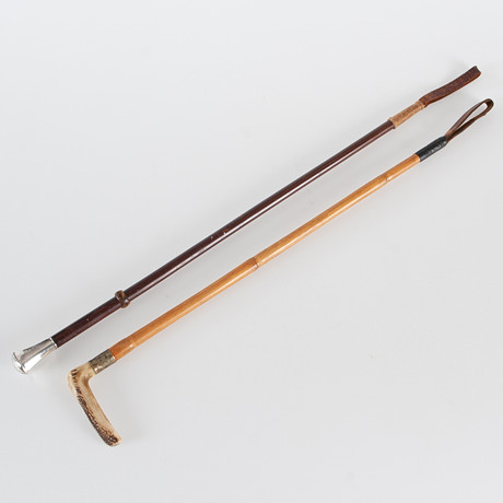 A set of two 20th century riding rods, one of which has a handle in ...