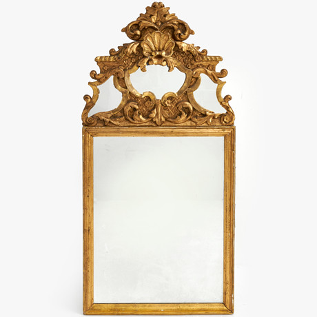 A rococo mirror field, 18th century, bronzed, traces of gilding, upper ...