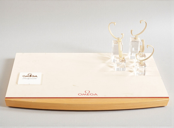 OMEGA. Wooden display with plate covered with leather, five display ...