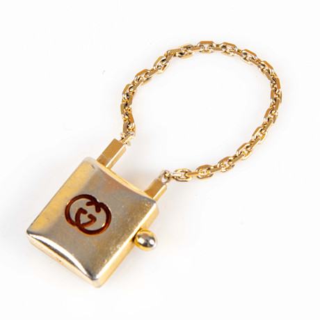 GUCCI . Väskberlock / nyckelring. Gulmetall.