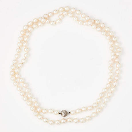 COLLIER, odlade saltvattenspärlor ca 7,4-7,6 mm, kulformat lås, 18 k satinerat vitguld, dekor med 5 små åttkan på auktion hos Stockholms Auktionsverk Magasin 5