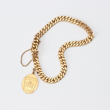 ARMBAND MED BERLOCK. 18k guld, pansarlänk, vikt ca 14,6 gram. på auktion hos Skånes Auktionsverk