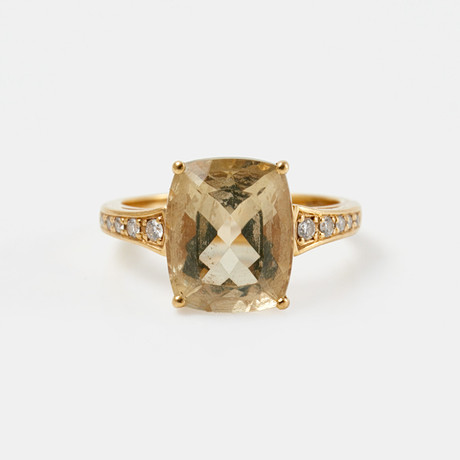 RING, 18 k guld, 1 kuddslipad citrin, flankerad av 10 briljantslipade diamanter, totalt ca 0,09 ct. på auktion hos Stockholms Auktionsverk Sickla